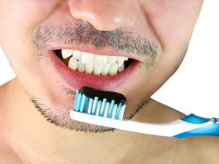 Closeup of man, brushing teeth with a blue tooth brush