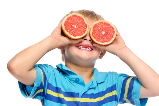 Boy plays with fresh fruit