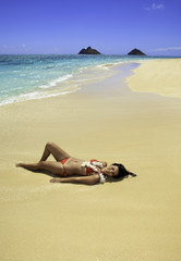Fototapeta na wymiar piękne polynesian wylegiwanie dziewczyna na piasku na brzegu
