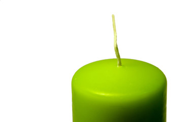 Зеленая свеча с фитилем на белом фоне