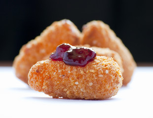 Fried camembert close up in white and black background