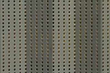 Silver metal plate with rows of holes
