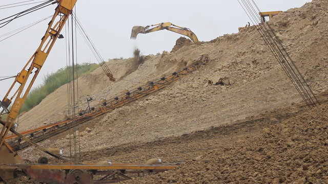 Excavators and Dredge digging clay
