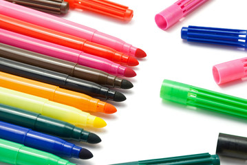 Closeup of colored markers with caps.