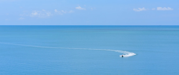 jetski racing on a blue water and blue sky as background