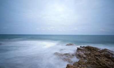 Long exposure photo of sea on rocks