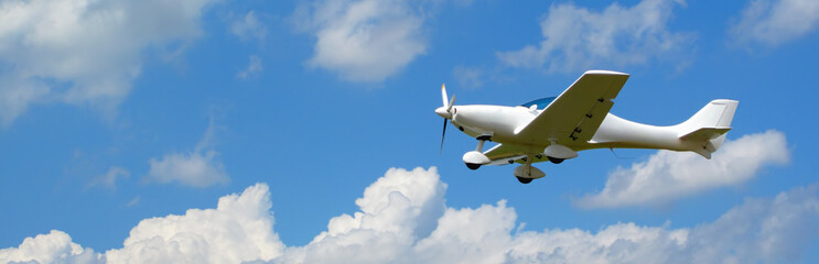Small aircraft flying in the blue sky, concept for banner.