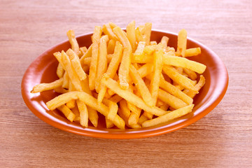 French fries on wooden background
