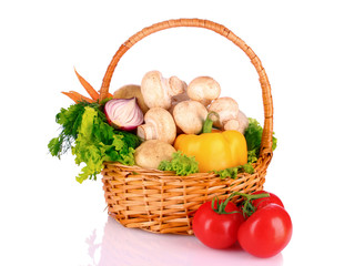 A set of vegetables in wricker basket isolated on white