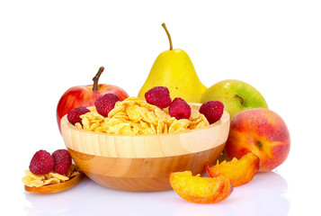 tasty cornflakes and fruit in wooden bowl isolated on white