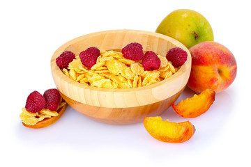 tasty cornflakes and fruit in wooden bowl isolated on white