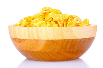 tasty cornflakes in wooden bowl isolated on white