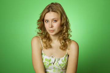 Beautiful young woman on green background