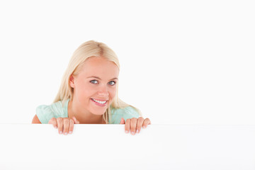 Smiling woman standing behind a whiteboard