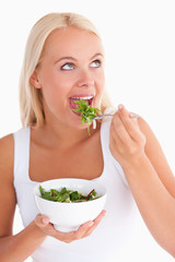 Charming woman eating salad