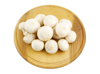 Fresh mushrooms on wooden cutting board isolated