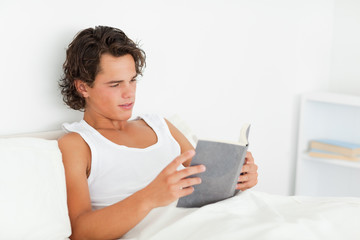 Fototapeta na wymiar Dark-haired man reading a book