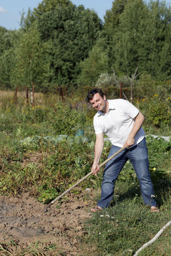 Man poses with rake