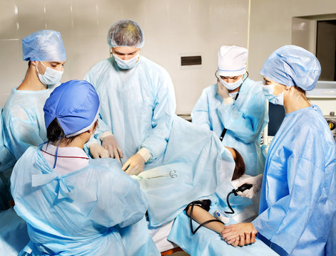 Group of surgeon looking at patient.