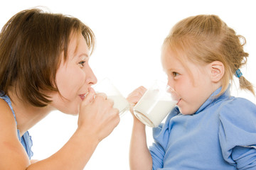 Mom and daughter drink milk.