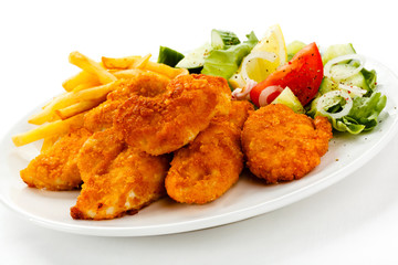 Fried chicken nuggets, French fries and vegetables