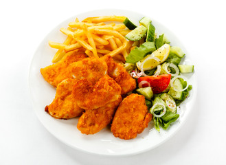 Fried chicken nuggets, French fries and vegetables