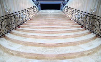 magnificent light marble staircase with ornate metal railings