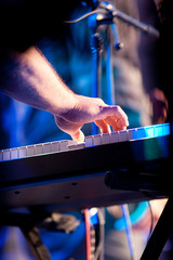 Hand on piano keyboard