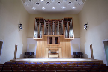 Massive wooden pipe organ in empty concert hall