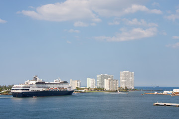 Coast Guard Escorting Blue and White Cruise Ship Past White Cond