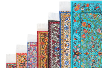 Seven varicoloured carpets lie stairs on growth on each other