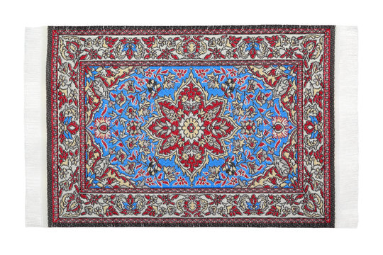 One oriental red-blue carpet horizontally lies on  white