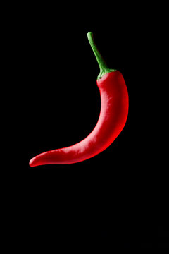 Hot Chilli Pepper Over Black Background