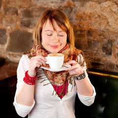 First capuccino - Beautiful young caucasian girl drinking coffee