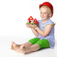Cute little girl with helmet dreaming of a new house