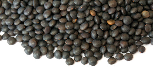 Heap of black lentil isolated on white