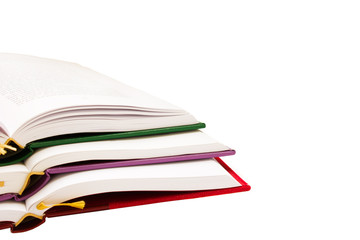pile of open books on white background