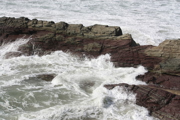 rough stormy coast with waves breaking on rock
