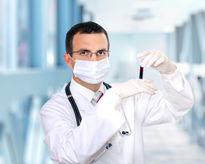 Doctor  resarch a medical test glass with blood.