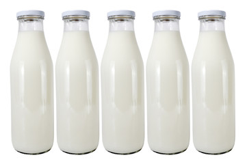 five glass bottles with milk