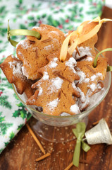 А bowl full of сhristmas cookies with ribbons.