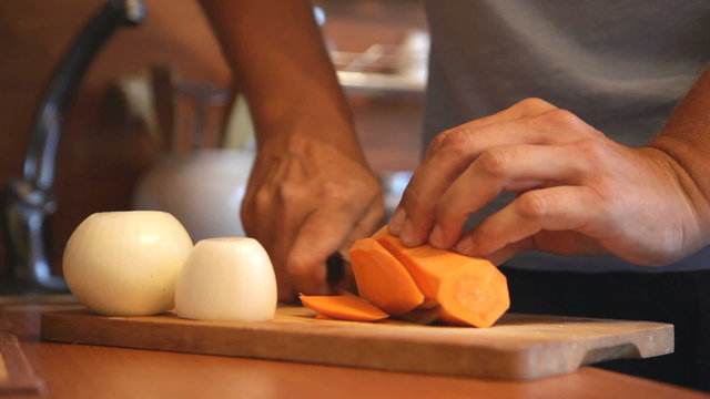 Male chef knife cut vegetables on a cutting board