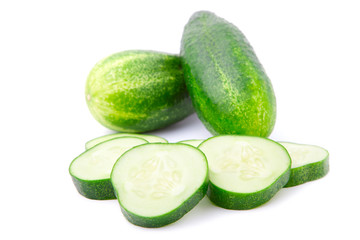 Cucumber and slices isolated over white background.
