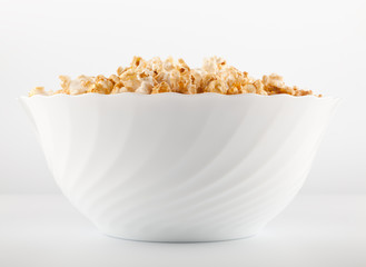 Big bowl of salty popcorn on light grey background