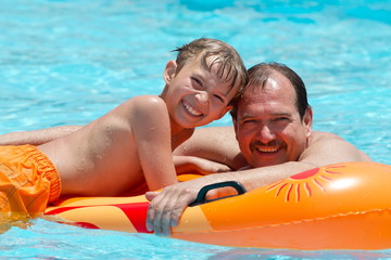 Father and son on water float