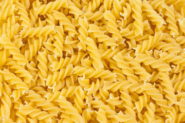 italian pasta fusilli yellow background