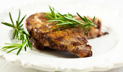 Grilled pork with rosemary sprigs