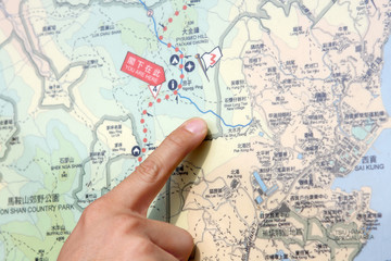 Close up of a hand pointing out location on the map.