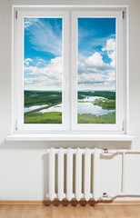 White plastic window with radiator under.View through glass