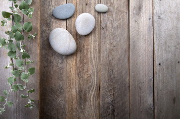 Leaves and stones over wooden background.